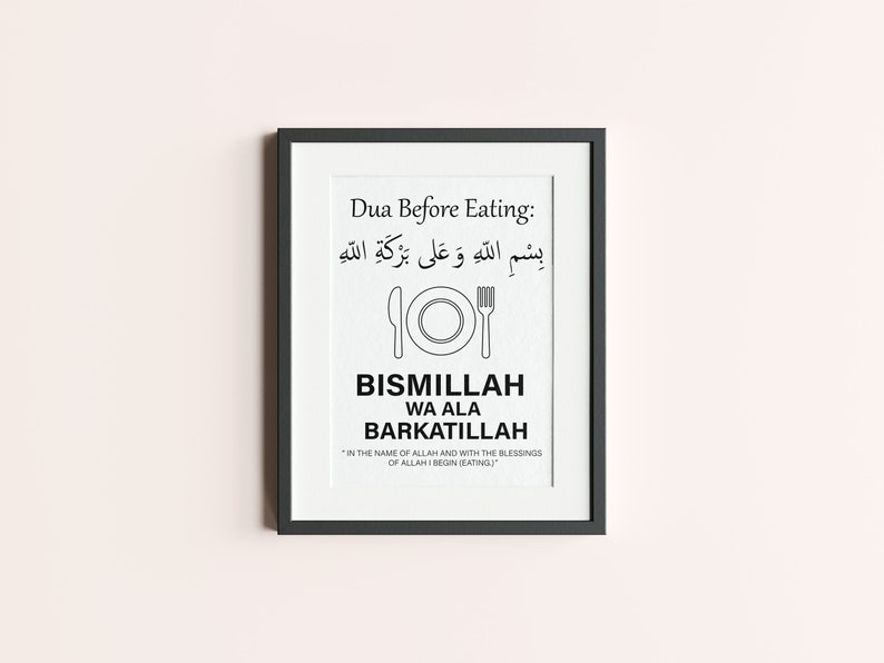 May include: Black framed print with the text "Dua Before Eating" in English and Arabic script. The print includes a plate and fork illustration, and the words "Bismillah Wa Ala Barkatillah". The bottom of the print reads "In the name of Allah and with the blessings of Allah I begin (eating)."