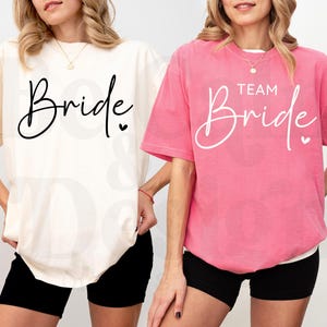 May include: Two white t-shirts with black text. One says "Bride" and the other says "Team Bride".