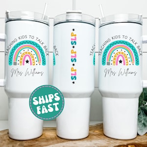 May include: White tumbler with a handle, lid, and straw. The design includes a rainbow, pencil, and the text "TEACHING KIDS TO TALK BACK" and "Mrs. Williams". The side of the tumbler has the text "SLP SLP SLP".