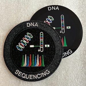 Può includere: Due toppe circolari con sfondo nero e bordi bianchi. Il testo DNA SEQUENCING è ricamato in bianco. Il design presenta una doppia elica del DNA colorata, un grafico verticale di un cromosoma e un cromatogramma a picchi multicolore.