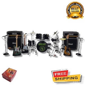 May include: A miniature Green Day drum set with two black Marshall amplifiers, two electric guitars, and microphones. The drum set includes a bass drum with the band's name, Green Day, printed on it.