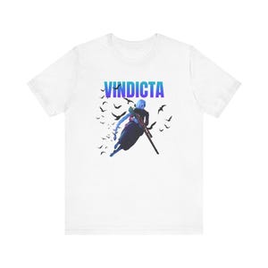 May include: White t-shirt with a blue and purple gradient graphic of a character holding a rifle, with the word "VINDICTA" in blue and purple letters above the character.
