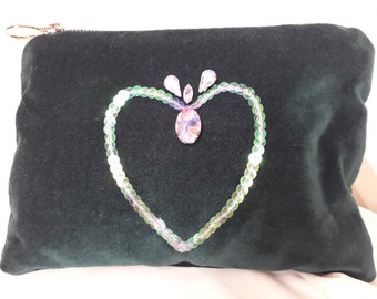 May include: A dark green velvet pouch with a heart-shaped design made of iridescent sequins and rhinestones.