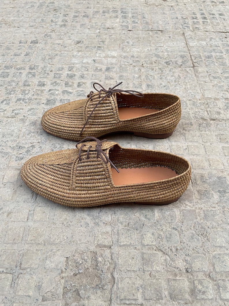 Handmade men’s raffia shoes crafted from natural woven fibers, featuring a lightweight and breathable loafer moccasin design. Ideal for weddings, beach ceremonies, summer outfits, and casual everyday wear. These artisanal raffia loafers offer a stylish, eco-friendly look with detailed handwoven texture, comfortable fit, and classic design suitable for men seeking unique, handcrafted footwear.