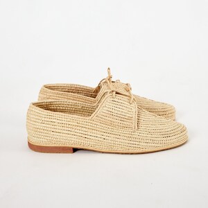 Handmade men’s raffia wedding shoes featuring natural woven fibers and a lightweight loafer design. Perfect for grooms seeking unique, stylish footwear for beach, boho, or summer ceremonies. Comfortable, breathable, and crafted with detailed handwoven texture for an elegant, natural look.
