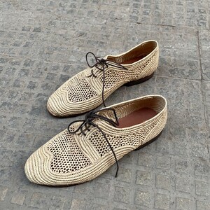 Handmade men’s raffia shoes crafted from natural woven fibers, featuring a lightweight and breathable loafer moccasin design. Ideal for weddings, beach ceremonies, summer outfits, and casual everyday wear. These artisanal raffia loafers offer a stylish, eco-friendly look with detailed handwoven texture, comfortable fit, and classic design suitable for men seeking unique, handcrafted footwear.