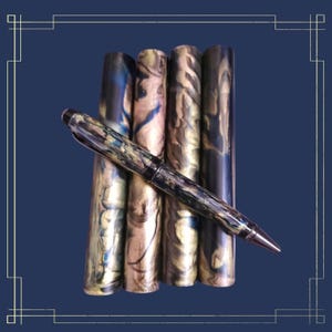 May include: Five pen blanks with a swirling pattern of blue, gold, and brown. A black and gold pen is lying on top of the blanks.