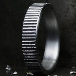 May include: A set of three ceramic mugs with a speckled, matte finish. The mugs are in shades of cream, light gray, and dark gray. Each mug has a simple, minimalist design, perfect for coffee or tea.