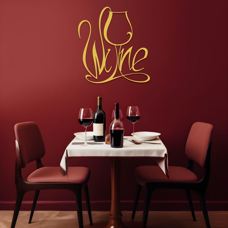 May include: A dining scene with a red wall and a small table set for two. The table has a white tablecloth, two wine glasses, and two bottles of wine. A gold-colored "Wine" sign is on the wall.