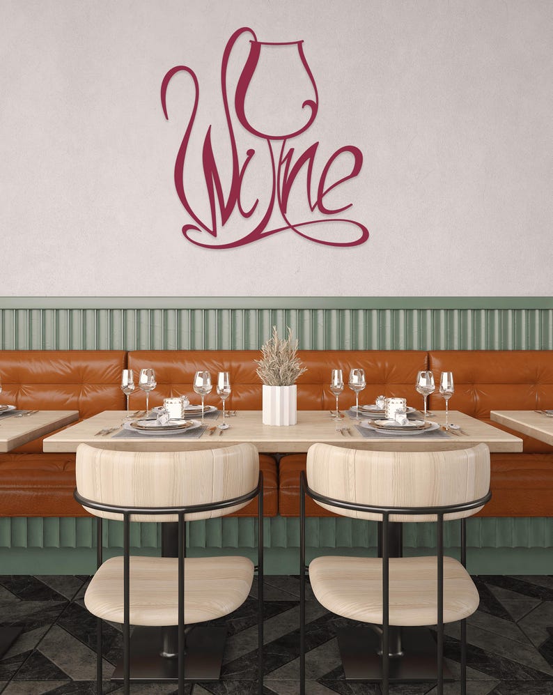 May include: A restaurant interior featuring a burgundy metal sign that reads "Wine" in a stylized script, with a wine glass design. The dining area includes tables, chairs, and a leather booth.