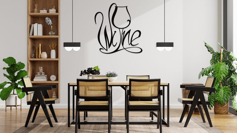 May include: A dining room scene featuring a wooden table and four chairs with woven seats. A black metal sign on the wall spells "Wine" in a stylized font. Two black pendant lights hang above the table.