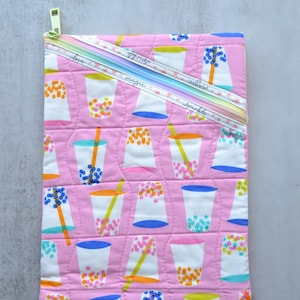 May include: A white ceramic mug with a black handle and the text "But First, Coffee" in a black, handwritten-style font. The mug is on a white surface.