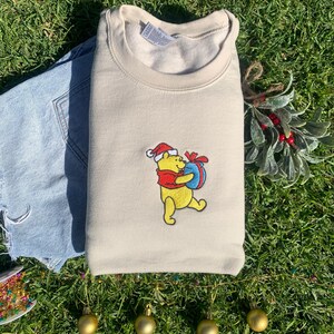 Pooh Bear&#39;s Present Embroidered Crewneck - Very Merry Christmas Edition 2024