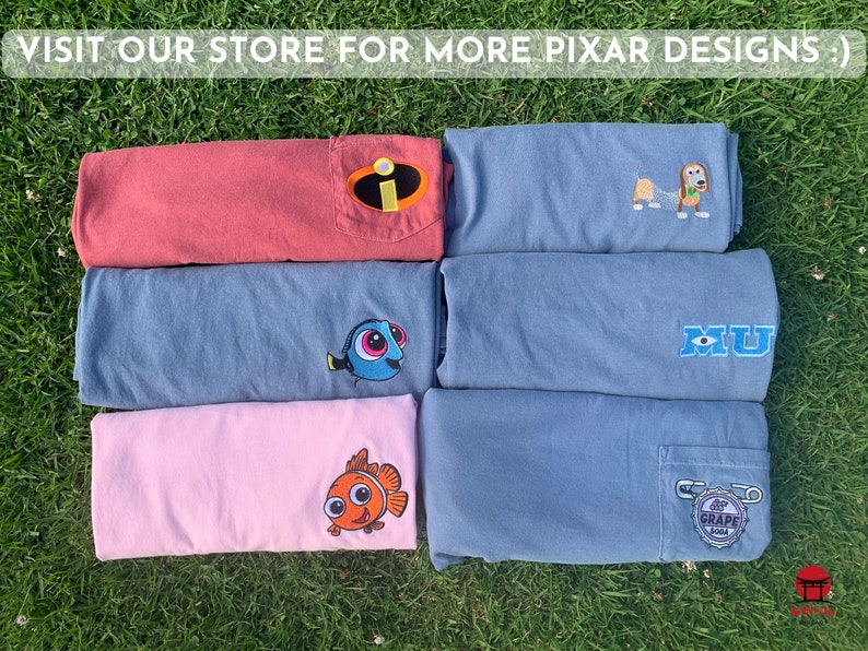 May include: Six folded t-shirts with different Pixar character designs. The shirts are in various colors, including red, blue, and pink. The designs include a character from the movie "Monsters Inc.", a character from the movie "Finding Nemo", and a character from the movie "Toy Story".