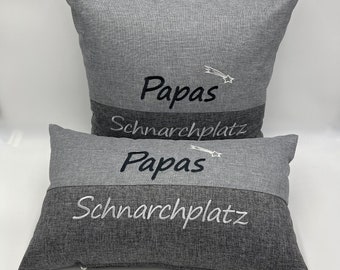 May include: Two gray pillowcases with the text "Papas Scharchplatz" embroidered on them. The pillowcases are made of a soft, textured fabric.
