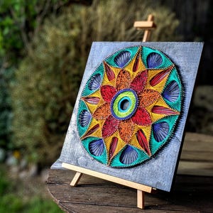 May include: A white ceramic mug with a black handle and the text "But First, Coffee" in a black, handwritten-style font. The mug is on a white surface.
