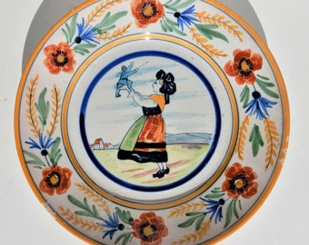 Antique plate, woman from Brittany holding a soldier, no mark, most likely from Notthern France
