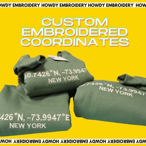 May include: Green sweatshirts with white embroidered coordinates and the text "New York" and "@howdyembroidery". The sweatshirts are stacked on a yellow background with the text "CUSTOM EMBROIDERED COORDINATES" in a colorful font.