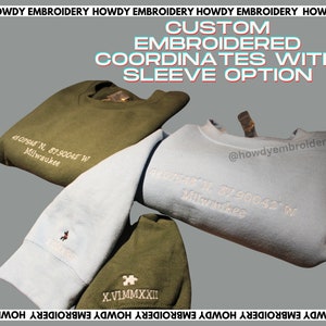 May include: Two sweatshirts with custom embroidery. One is light blue with white embroidery of coordinates and the text "Milwaukee". The other is dark green with white embroidery of Roman numerals and the text "Milwaukee".