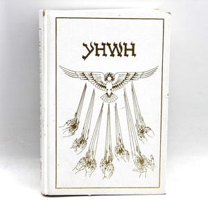May include: A white book with gold lettering and illustrations. The cover features the word "YHWH" above a design of a bird with outstretched wings, from which rays emanate, ending in hands.
