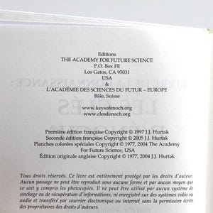May include: Open book pages with text from "THE ACADEMY FOR FUTURE SCIENCE" and "L'ACAD&Eacute;MIE DES SCIENCES DU FUTUR - EUROPE". The text includes copyright information and website addresses. The book is open to a page with French text.