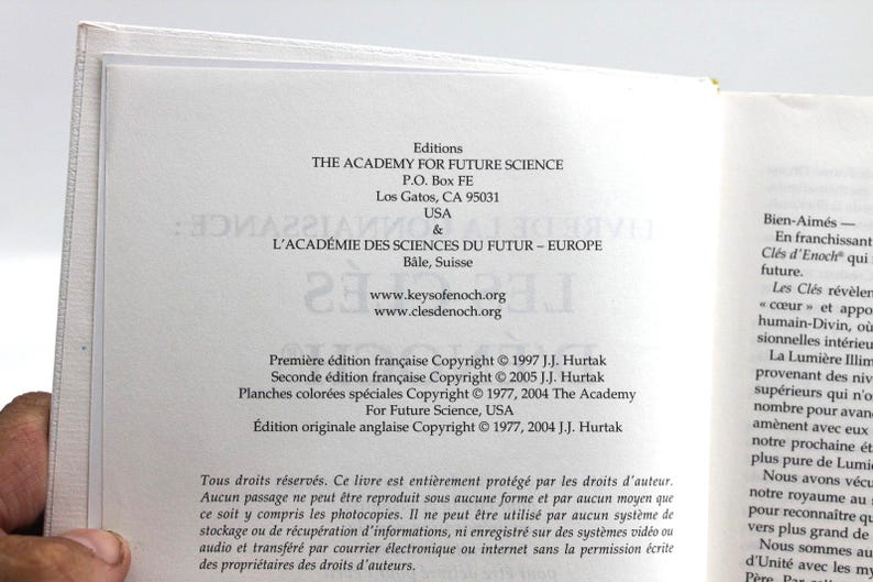 May include: Open book pages with text from "THE ACADEMY FOR FUTURE SCIENCE" and "L'ACAD&Eacute;MIE DES SCIENCES DU FUTUR - EUROPE". The text includes copyright information and website addresses. The book is open to a page with French text.