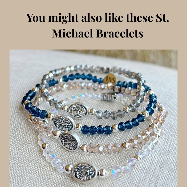 May include: Several beaded bracelets in shades of blue, clear, and pink. Each bracelet features small, round beads and a silver oval charm. The text "You might also like these St. Michael Bracelets" is at the top.