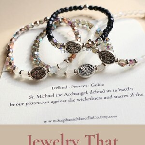 May include: Three beaded bracelets with oval charms are displayed. The bracelets are black, white, and iridescent. Text on the image reads "Best Protection Bracelets" and "Jewelry That Inspires Strength & Faith."