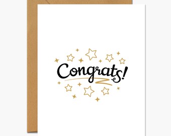 May include: A white greeting card with the word "Congrats!" in black script, surrounded by gold stars. The card is inside a brown envelope, perfect for celebrating achievements.
