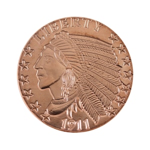 May include: A copper-colored coin with the image of an American Indian wearing a feathered headdress. The coin has the word "LIBERTY" inscribed around the top edge and the year "1911" inscribed at the bottom.