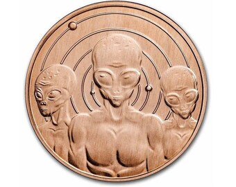 May include: A copper-coloured coin featuring three alien faces. The central alien is larger and has a more detailed face. The two smaller aliens are on either side of the central alien. The coin has a circular design with concentric circles around the aliens.