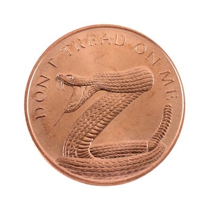 May include: A copper-colored coin with a rattlesnake and the words "Don't Tread On Me" engraved on it.