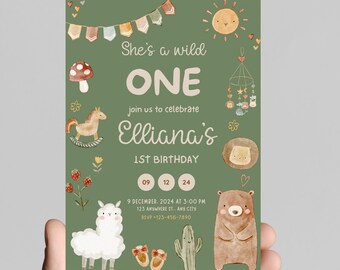 May include: A green birthday invitation with watercolor illustrations. The text reads "She's a wild ONE" and "Elliana's 1st Birthday." The design includes a llama, bear, cactus, and other whimsical elements. The date and time are also included.