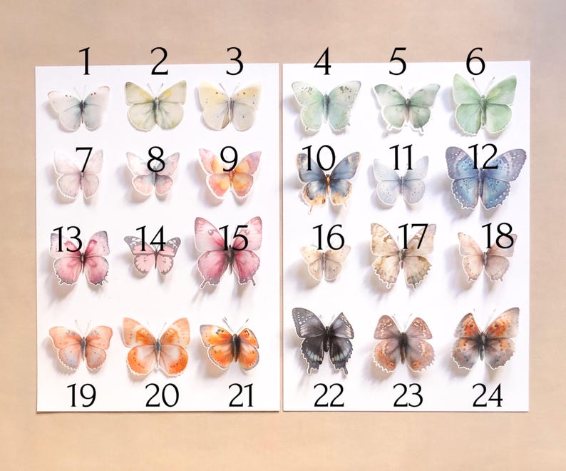 May include: A collection of twenty-four individual butterfly stickers arranged on two white sheets, numbered 1 through 24. Each butterfly features distinct colour patterns, including shades of blue, pink, orange, yellow, green, and black.