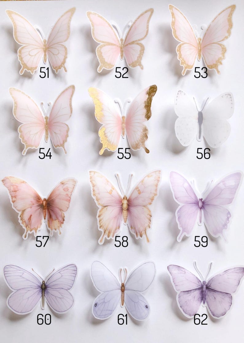 May include: A collection of twelve butterfly stickers arranged in a grid, labelled with numbers 51 through 62. The stickers feature various shades of pink, purple, and white, with some designs incorporating gold foil accents on the wings.