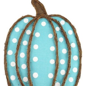May include: A blue and white polka dot pumpkin door hanger made of woven twigs.