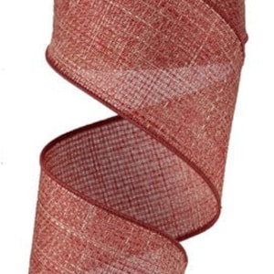 May include: A roll of 2.5 inch wide red and white burlap ribbon with a textured finish. The ribbon is perfect for crafting and decorating.