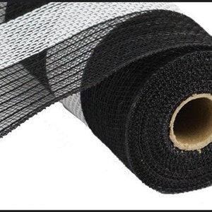 May include: Black and white striped mesh ribbon roll. The ribbon is black with white stripes and is rolled up on a cardboard tube.