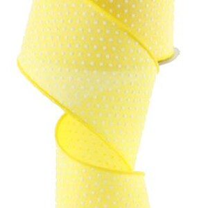 May include: A spool of yellow ribbon with white polka dots. The ribbon is 2.5 inches wide.