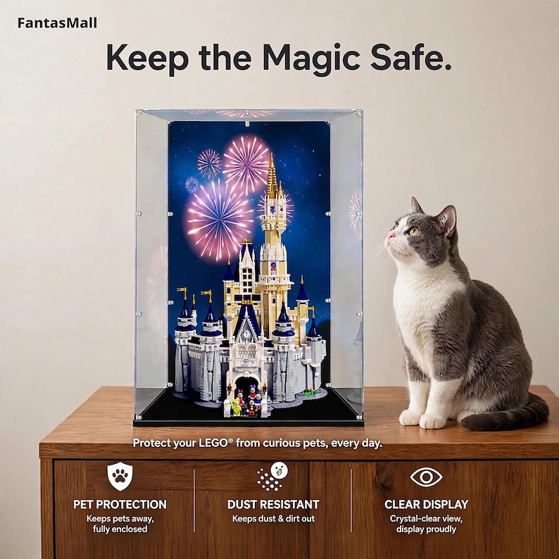 a gray and white cat sitting next to a display case containing a Lego castle, with fireworks visible in the background.