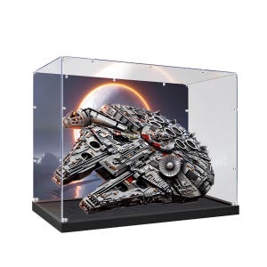 May include: A clear acrylic display case with a black base containing a detailed gray and white model of a starship. The background inside the case features a printed image of a large glowing planet or moon in a dark space setting with snowy terrain.