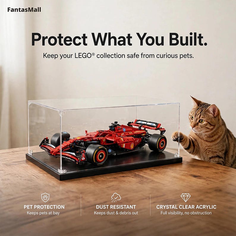 a LEGO® set displayed in a clear case, with a cat sitting next to it on a wooden table.