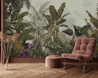 May include: A plush, dusty rose armchair with a chrome frame sits in front of a wall mural depicting a lush tropical jungle scene. A matching dusty rose ottoman sits in front of the chair.