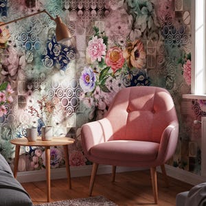 May include: A pink upholstered armchair with two button tufts on the backrest and light-colored wooden legs. The chair is positioned next to a small round wooden side table holding two white mugs and a small vase with dried flowers.