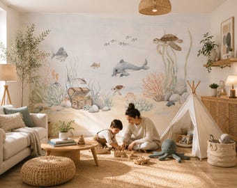 May include: A wall mural featuring a watercolor-style underwater scene with a dolphin, a sea turtle, various fish, and a treasure chest on the sandy ocean floor. The design includes soft-toned coral, seaweed, and rocks against a light background.