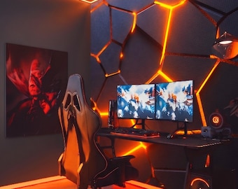 May include: A gaming setup featuring a black desk, a high-back ergonomic chair, and two computer monitors displaying colorful graphics. The wall behind the desk has a geometric pattern illuminated by orange LED lights, matching the floor lighting.