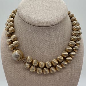 Vintage gold tone double strand metal beaded necklace