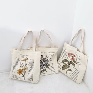 Bolso de mano floral｜Lindo bolso de lona con estampado botánico｜Bolsa de mano reutilizable de flores con cremallera y bolsillo｜Bolsa de mano de lona de regalo de regreso a la escuela