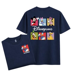 May include: Navy blue t-shirts featuring Disney characters. The front shirt has a small Donald Duck graphic with the name "ANDRE". The back of the shirt has Mickey Mouse, Daisy Duck, Minnie Mouse, Goofy, Donald Duck, and Pluto, with the Disneyland logo.