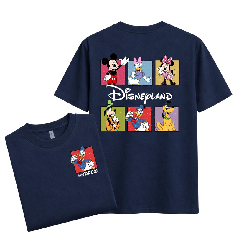 May include: Navy blue t-shirts featuring Disney characters. The front shirt has a small Donald Duck graphic with the name "ANDRE". The back of the shirt has Mickey Mouse, Daisy Duck, Minnie Mouse, Goofy, Donald Duck, and Pluto, with the Disneyland logo.
